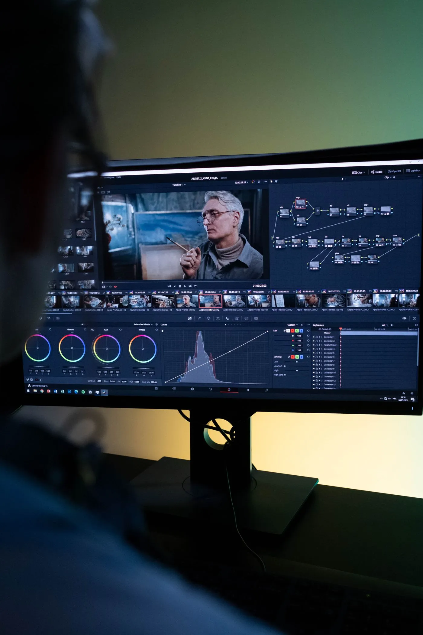 An editor reviewing a color grade on a wide monitor