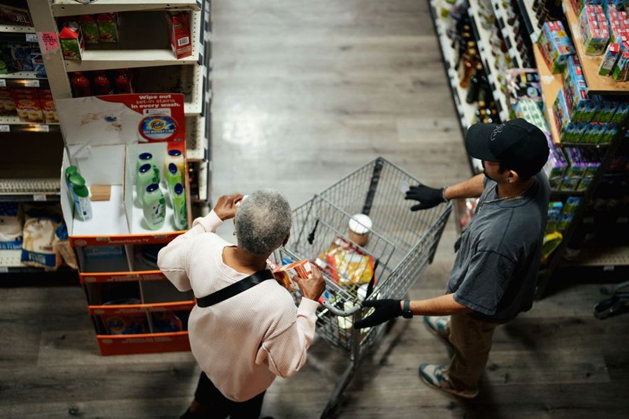 Overhead view of a camera following a shopper down a grocery aisle